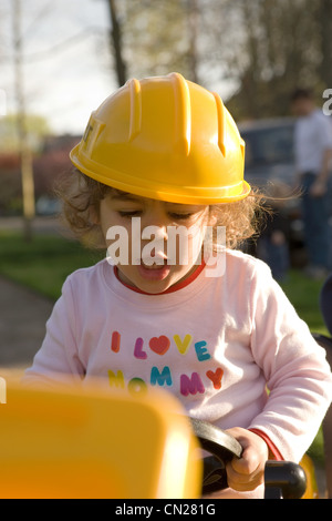 Young girl dressed up in hard hat Stock Photo