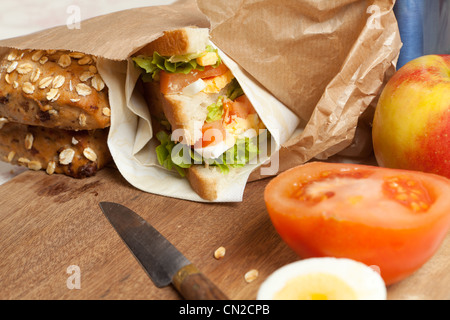 Sandwiches buns and apples in a brown paper lunch bag Stock Photo