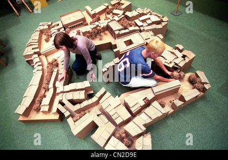 Two University of Brighton Architecture students build a wooden model of of a housing development. Stock Photo