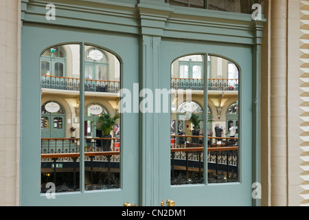 Mirrored double doors reflecting the Corn Exchange building interior in Leeds, West Yorkshire, England, UK, Britain. Stock Photo