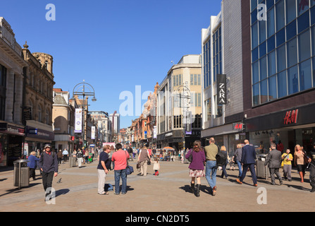Busy main high street scene with people shopping in the city centre pedestrian precinct. Briggate, Leeds, West Yorkshire, England, UK, Britain