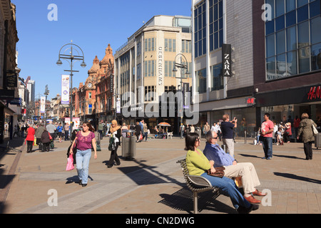 Busy pedestrian main high street scene with people shopping in city centre on Briggate, Leeds, West Yorkshire, England, UK, Britain Stock Photo