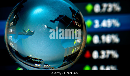 Glass globe over stock data on computer screen Stock Photo