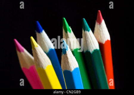 Color pencils on black background. Selective focus. Stock Photo