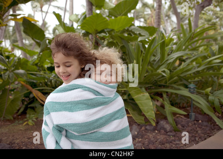 Boy and girl wrapped in towel Stock Photo