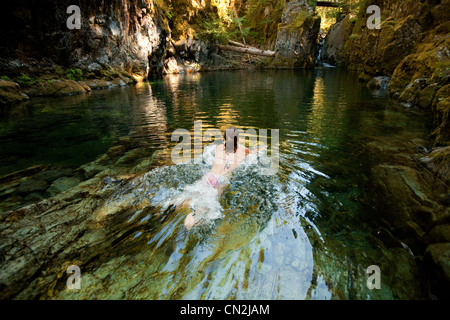 Woman swimming in river Stock Photo