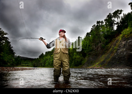 Fly fisherman in Margaree River, Cape Breton Island, Nova Scotia Stock Photo