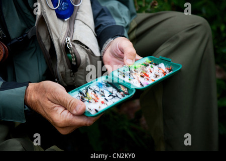 Person holding fly fishing lures, close up Stock Photo