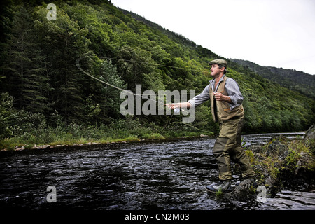 Fly fisherman in Margaree River, Cape Breton Island, Nova Scotia Stock Photo