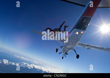 Skydiver jumping from plane over north shore of Oahu, Hawaii Stock Photo