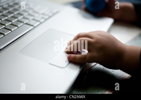 Toddler using laptop, close up Stock Photo