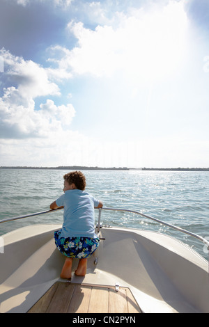 Young boy looking at view from motorboat Stock Photo