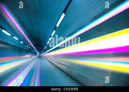 Abstract speed motion in urban highway road tunnel, blurred motion toward the light Stock Photo