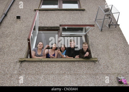 Five children looking out of window Stock Photo