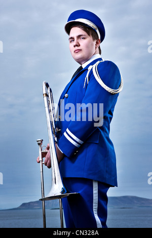 Portrait of young man holding trombone Stock Photo