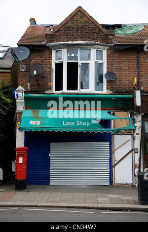 Abandoned and boarded up / closed / shut-up derelict shop (former GPO sub - Post Office) in Twickenham. London. UK. Stock Photo