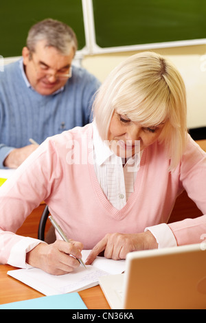 Vertical shot of a senior couple studying diligently Stock Photo