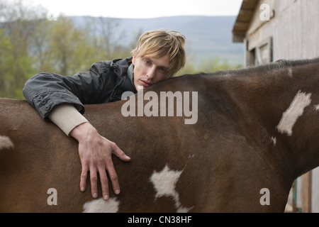 Man leaning on horse Stock Photo