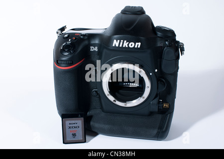Nikon's flagship professional DSLR camera the D4. Seen here on white background with the new Sony XQD card only used in the D4. Stock Photo