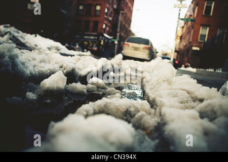 Snow turning to slush on road Stock Photo