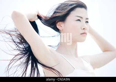 Young woman with long windswept black hair