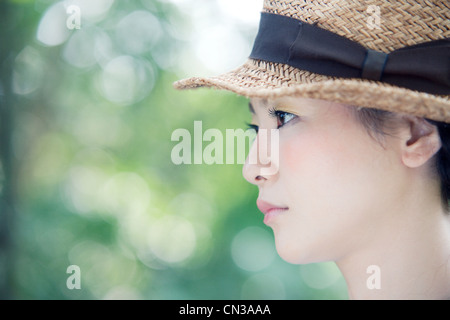 Young woman wearing straw hat, portrait