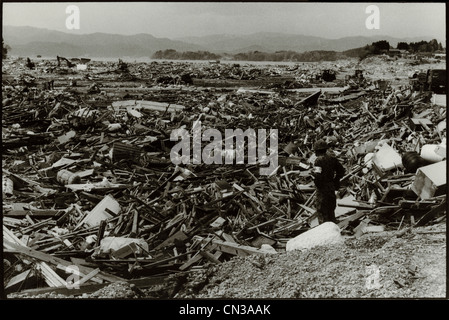 Rikuzentakata, Japan- 20th March 2011: Soldier amongst debris in aftermath of the 2011 Tohoku Earthquake and Tsunami Stock Photo