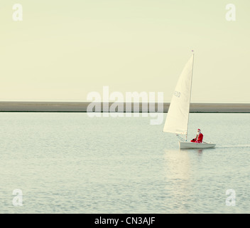 Person dressed up as santa claus in boat on lake Stock Photo