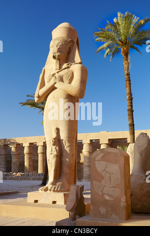 Karnak, Egypt - Statue of Pharaoh Ramses II with Queen Nefertari in the Great Courtyard, Amun-Re Temple, Karnak temple, Egypt Stock Photo