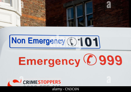Close up of non emergency and emergency telephone phone numbers number on police van vehicle England UK United Kingdom GB Great Britain Stock Photo