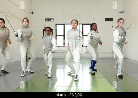 Portrait of female fencers holding foils Stock Photo