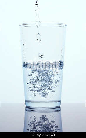 Pouring water into glass Stock Photo