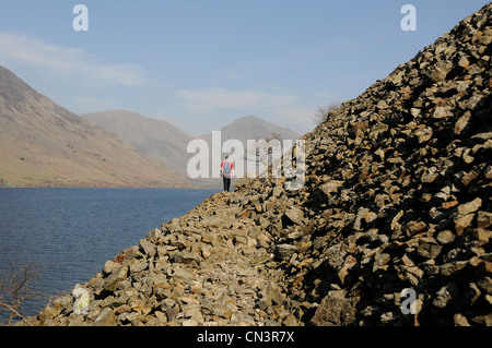 Young man walking on the screes at wastwater in the lake district uk Stock Photo