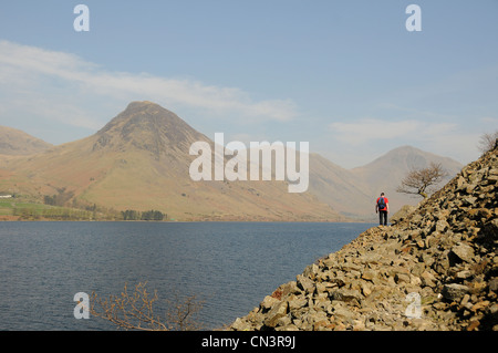 Young man walking on the screes at wastwater in the lake district uk Stock Photo