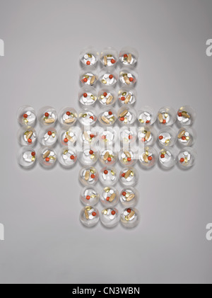 Pill containers arranged in cross shape Stock Photo