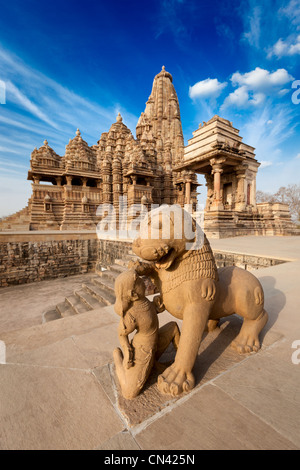 King and lion fight statue and Kandariya Mahadev temple. Khajuraho, India Stock Photo