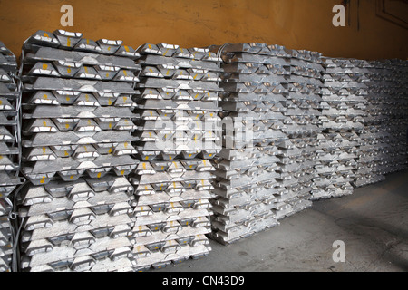 Aluminum bricks on non-ferrous metallurgical plant. Russian metallurgy factory. Along wall Stock Photo