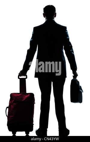 rear view one caucasian business traveler man walking with suitcase standing  full length silhouette in studio isolated white backgroun Stock Photo