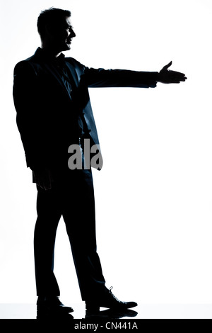 one caucasian man handshake profile  full length silhouette in studio isolated white background Stock Photo