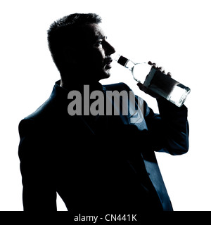 one caucasian man portrait silhouette drunk puring empty alcohol botlle in studio isolated white background Stock Photo