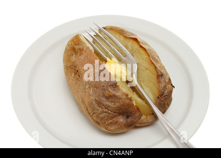 Closeup of a plain baked potato with melting butter on a fork Stock Photo