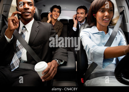 Businessmen and women haring car to work Stock Photo