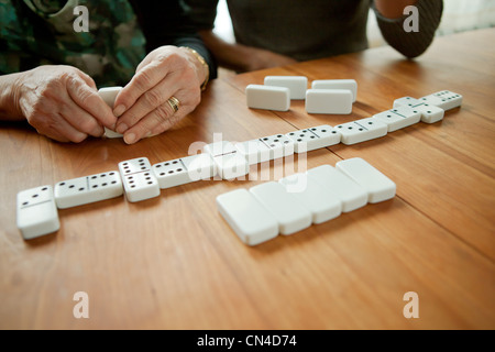 Mother and adult daughter playing dominoes Stock Photo