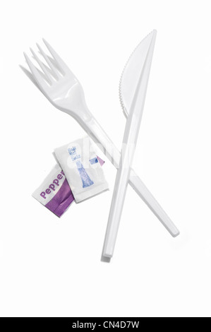 A plastic knife and fork with salt and pepper sachets Stock Photo