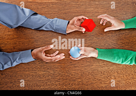 People exchanging colourful shapes Stock Photo