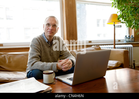 Senior man working on laptop, portrait Stock Photo