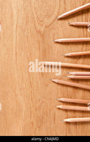 Wooden pencils on wooden background Stock Photo