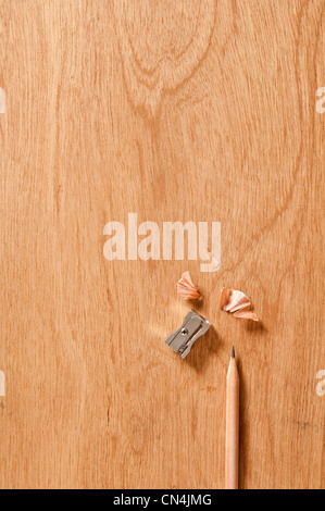 Pencil and sharpener on wooden background Stock Photo
