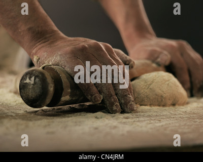 Baker rolling dough Stock Photo