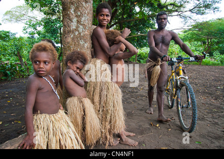 Vanuatu, Tafea Province, Tanna Island, Yakel Kastom Village, man and children playing with a mountain bike Stock Photo